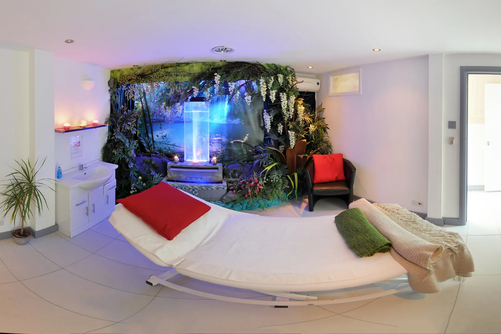 A themed treatment room set up for a facial, with florals and ambient light