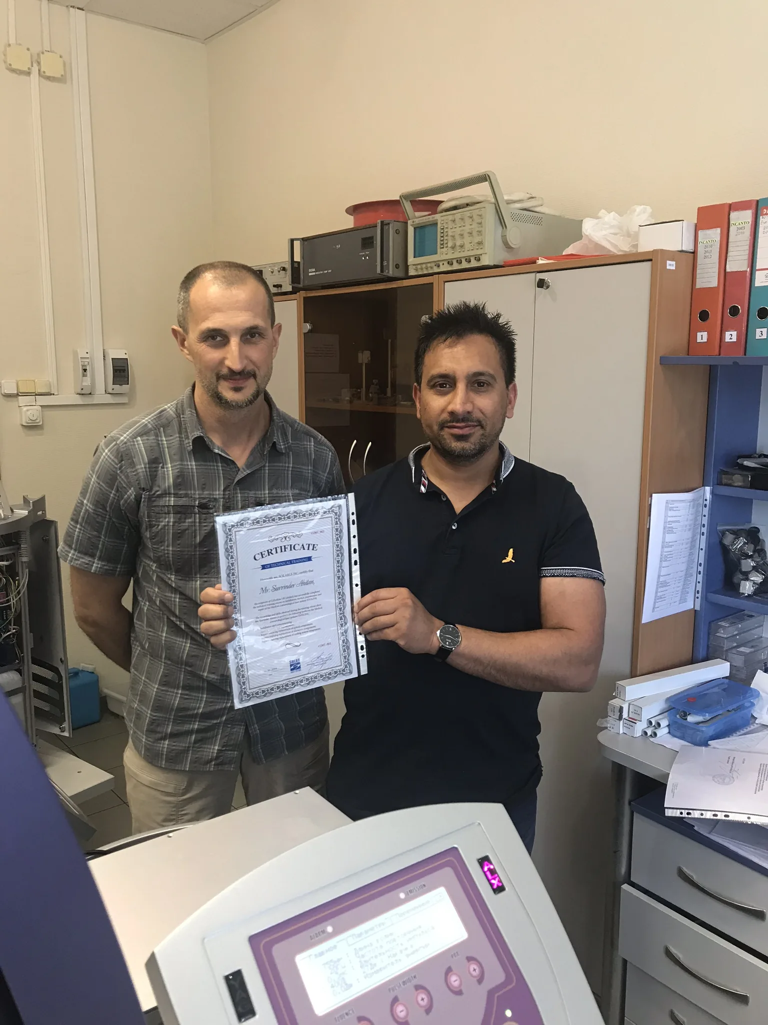 Surinder Ahitan holding his laser engineering training certificate.