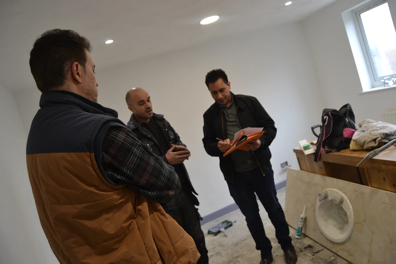 Surinder Ahitan reviewing a clinic refurbishment on site with the builder.