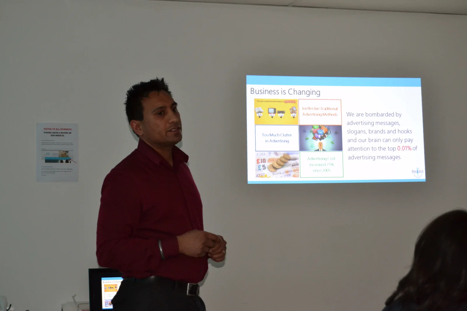 Surinder Ahitan teaching franchise clinic owners about marketing, presenting a slide headed 'Business is Changing'.