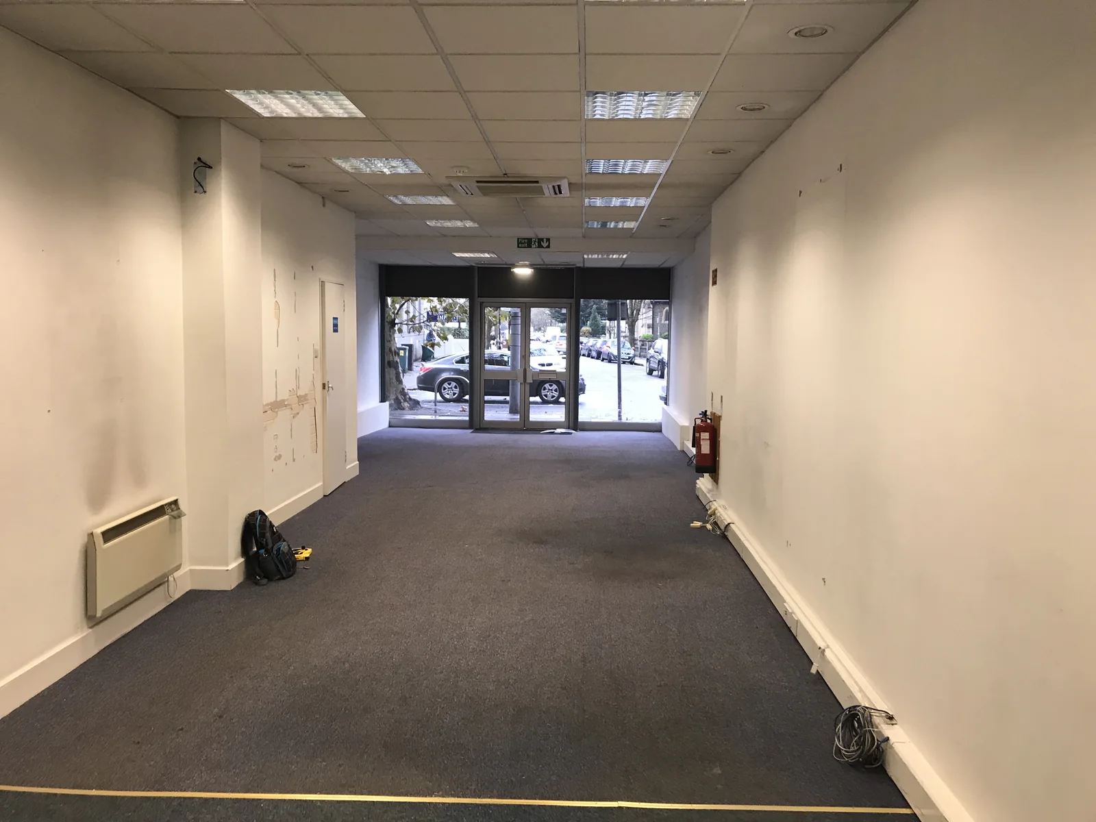 An empty retail unit with a shop front, before any clinic fit-out.