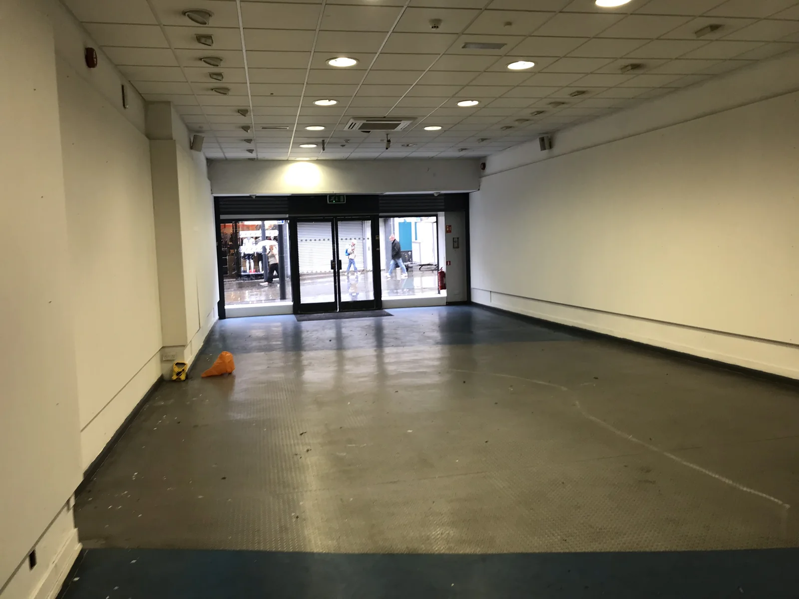 Another empty retail unit before fit-out, bare floor and walls.
